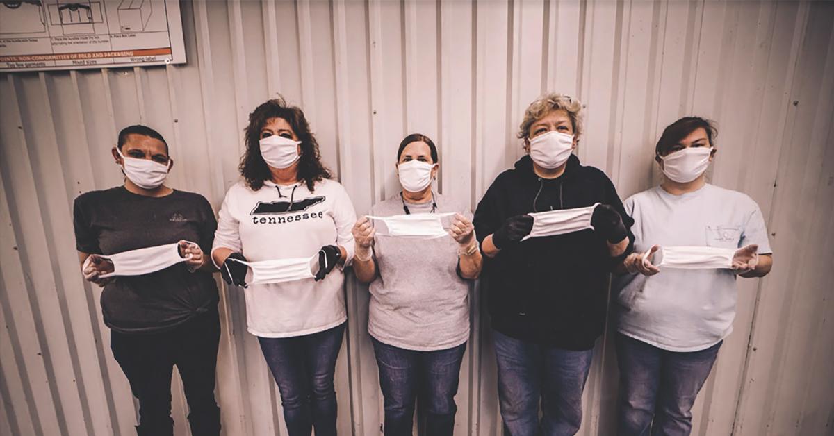 SanMar employees show off a few of the facemasks