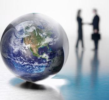 handshake with globe in foreground